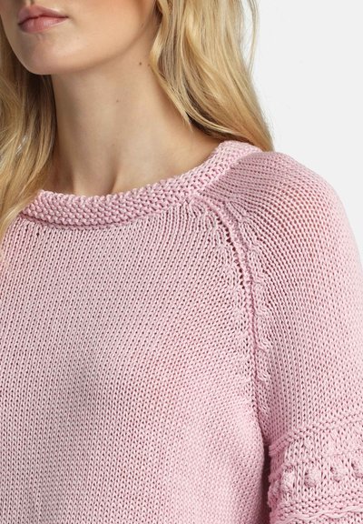 Suéter tejido de color rosa claro con punto texturizado, cuello ancho y detalles en los hombros y las mangas.