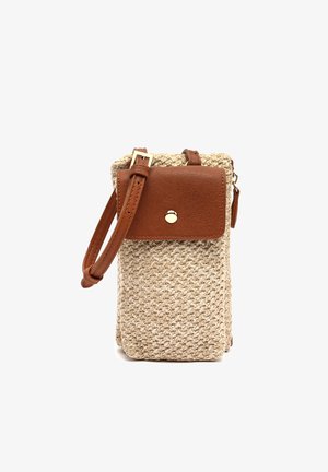 Small beige woven crossbody bag with brown leather flap, gold button, and adjustable strap.