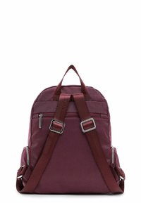 Petit sac à dos texturé bordeaux avec deux bretelles ajustables, une poignée supérieure et une poche zippée à l'arrière.