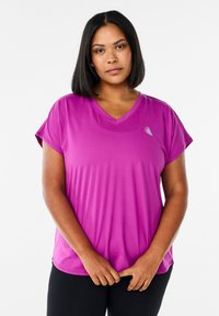 Purple short-sleeve athletic shirt with a V-neck design and subtle logo detail. Made from lightweight, smooth fabric.