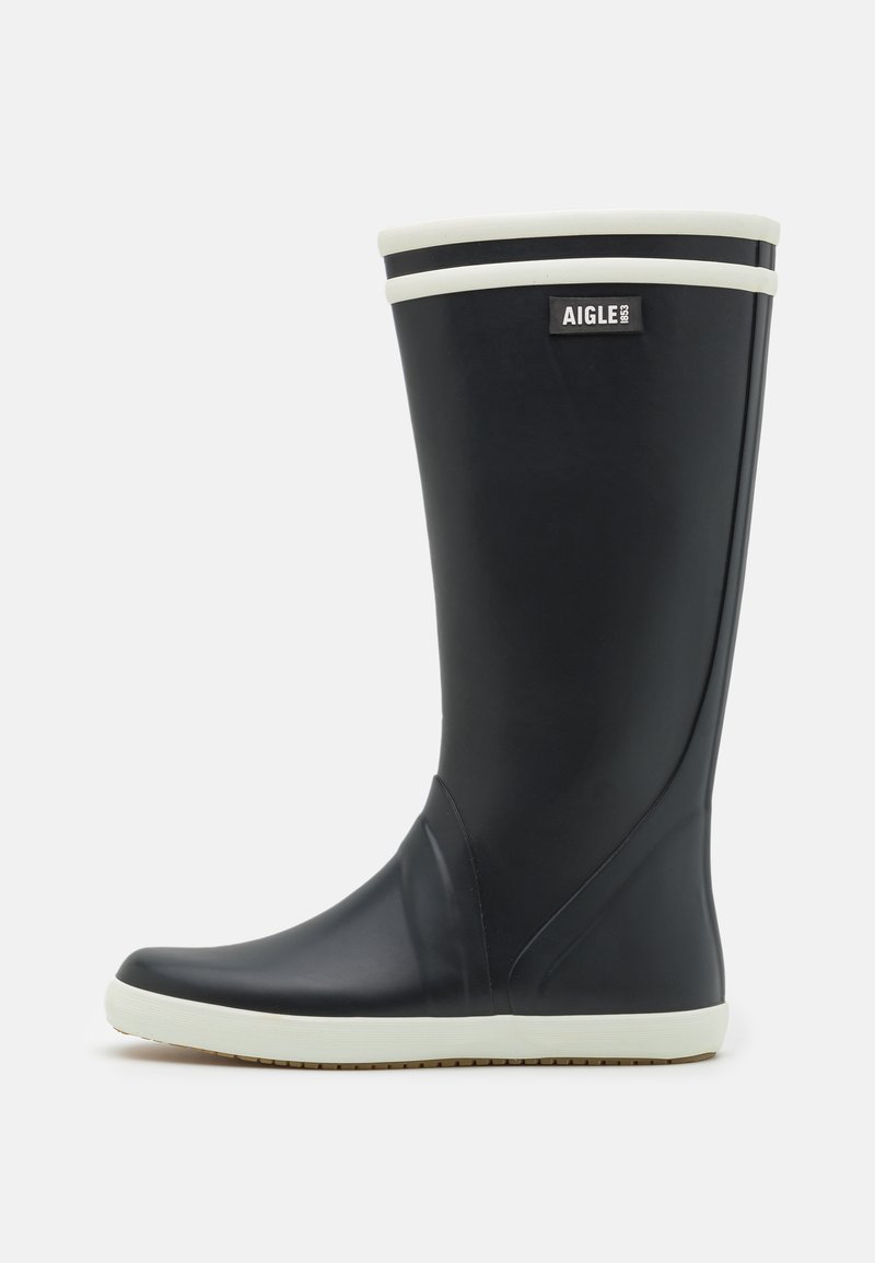 Botte de pluie noire en caoutchouc avec des accents blancs, présentant un bout rond, une surface texturée et un logo en haut. Hauteur mi-mollet.