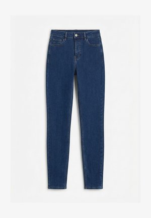 Donkerblauwe high-waist skinny jeans met knoopsluiting aan de voorkant en een ontwerp met vijf zakken, plat neergelegd op een witte achtergrond.