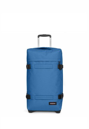 Blue wheeled suitcase made of durable fabric, featuring a telescopic handle, compression straps, and a front pocket with a logo.