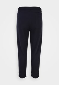 Marineblauwe sweatpants met een gladde textuur, elastische tailleband en boorden, voorzien van een enkele achterzak. Casual fit en maximaal tot de kuit.