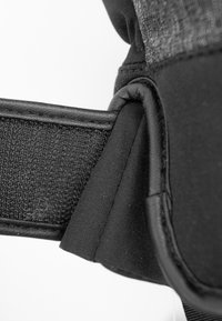 Black fabric strap with a textured surface, featuring smooth, rounded edges and reinforced stitching, highlighting the durable construction.