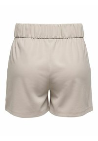 Beige, high-waisted shorts made of soft fabric with an elastic waistband, featuring a smooth texture and a relaxed fit.
