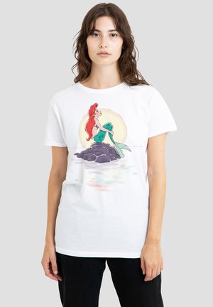 White cotton t-shirt featuring a colorful illustration of a mermaid sitting on a rock with a light-colored background.