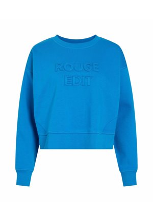 Sininen lyhyt collegepaita, jossa on kirjailtu teksti "ROUGE EDIT", pyöreä pääntie ja resorit hihansuissa, valmistettu pehmeästä puuvillasekoitekankaasta.