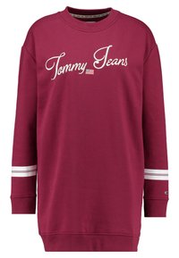Musta huppari pitkillä hihoilla, jossa on valkoinen brodeerattu "Tommy Jeans" -logo ja kaksi valkoista vaakaraitaa kummallakin hihalla.