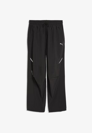 Pantaloni sportivi neri con vita elastica, coulisse, tasche con zip e dettagli con strisce riflettenti sulle gambe, con logo Puma sul lato destro.