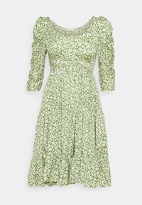 Green floral dress with three-quarter puff sleeves, a fitted bodice, and a flared, tiered skirt. Fabric features small white flowers.