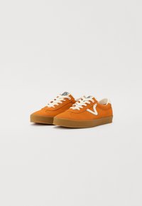 Orange suede sneakers with white laces and logo, featuring a rounded toe and gum rubber sole. Includes stitched detailing on the upper.