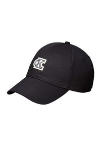 Gorra de béisbol negra con visera curva y una etiqueta rectangular blanca que muestra el logo "cK" en el panel frontal.