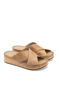 Brązowe skórzane sandały na koturnie z krzyżowym designem pasków, wyściełaną wkładką i przeszytymi detalami. Drewniana platforma dodaje wysokości.