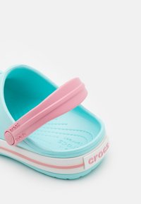 Blue and pink Crocs sandal with a smooth, textured footbed, wide strap, and white base featuring "CROCS" logo and pink accent band.
