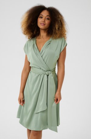 Hellgrünes Wickelkleid aus weichem Stoff, mit einem tiefen V-Ausschnitt, kurzen Ärmeln und einem gebundenen Taillenzug für eine verstellbare Passform.