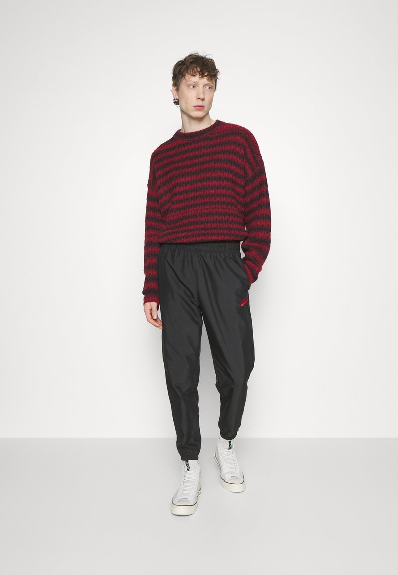 black and red nike tracksuit bottoms