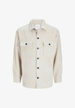 Beige long-sleeve button-up shirt jacket with two front flap pockets and black buttons, collar, and cuff details.