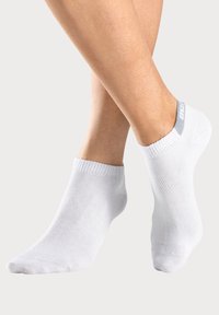 White ankle socks made of soft fabric, featuring a ribbed cuff and a logo in light gray on the heel for added detail.