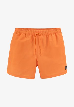 Bañadores de color naranja brillante con una cintura elástica y cordón ajustable. Presenta un pequeño parche de logo negro en la parte inferior derecha.