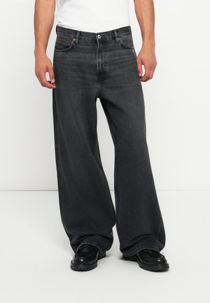 Donkergrijze wijde jeans met een hoge taille, vijf-pocket ontwerp en contrasterende stiksels. De stof heeft een zachte, denimtextuur.