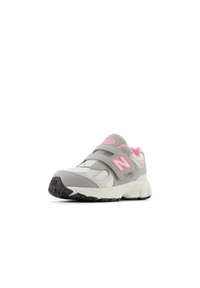 Gray athletic shoe with pink accents, featuring a suede and mesh upper, two velcro straps, and a textured rubber sole.