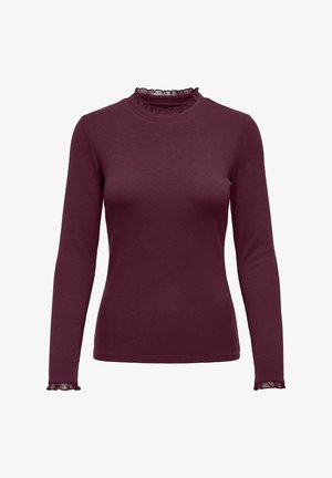 Burgundská dlouhá rukávová blůza s žebrovanou texturou, má volánový límec a manžety. Klasický střih a měkká látka.