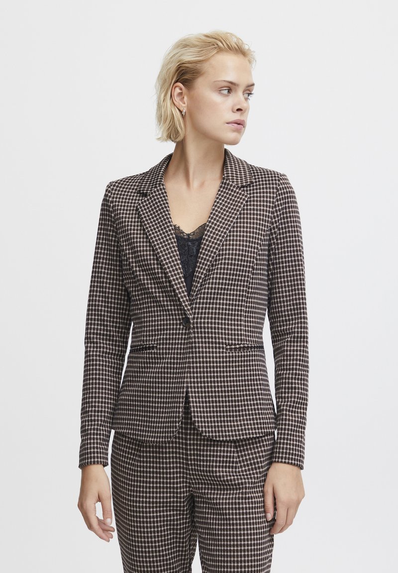 Brown checkered blazer made of textured fabric, featuring a single button closure, lapels, and two front pockets. Paired with coordinating pants.