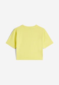 Lyhythihainen, lyhyeksi leikatun t-paita kirkkaankeltaista puuvillaa. Suora pinta, jossa pyöreä pääntie ja yksinkertaisia ommeltyön yksityiskohtia.