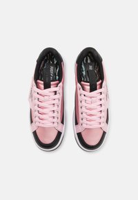 Rosa lädersneakers med svarta accenter. Funktioner inkluderar platta snörningar, en texturerad innersula och en logotagg på tungan. Rundad tåkonstruktion.