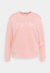 Felpa rosa chiaro con maniche lunghe, polsini a costine e collo tondo. Presenta il testo ricamato bianco "Tommy Hilfiger" sul davanti.