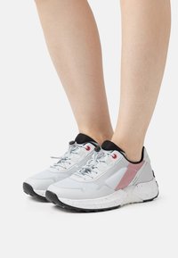 Men's athletic shoes in gray and white with red accents, mesh and synthetic upper, textured sole, and rounded toe design.