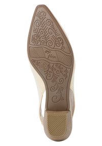 Podešev boty s detailním květinovým vzorem, vyrobená z pružného hnědého materiálu s texturovaným gripem a hladkým béžovým povrchem.