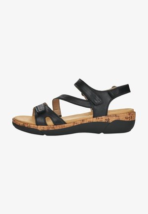 Sandali in pelle nera con suola in sughero e gomma nera. Presentano cinturini incrociati e lati aperti per una maggiore traspirabilità. Design della soletta confortevole.