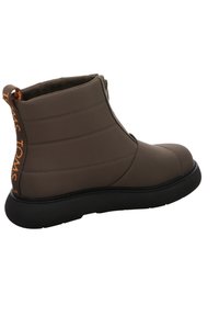 Brown ankle boot made of smooth material, featuring a quilted design, black rubber sole, and an orange logo accent on the heel.