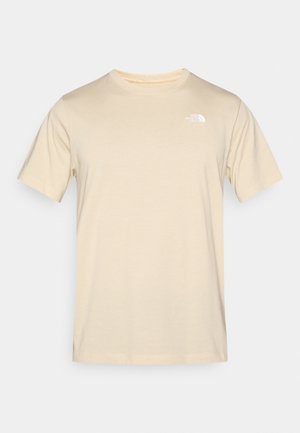 Beige bomulls-t-skjorte med korte ermer, rund hals og lite hvitt logo på venstre bryst. Glatt tekstur og standard passform.