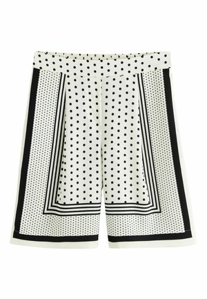 Schwarz-weiße Shorts mit Polka-Dot-Muster und gestreiften Randdetails auf weißem Hintergrund, mit elastischem Bund.