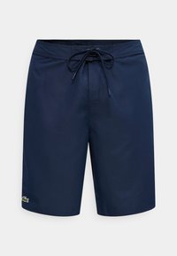 Μπλε σκούρο μαγιό βερμούδα με κορδόνι στη μέση και μικρό πράσινο λογότυπο κροκοδείλου στο κάτω αριστερό πόδι.