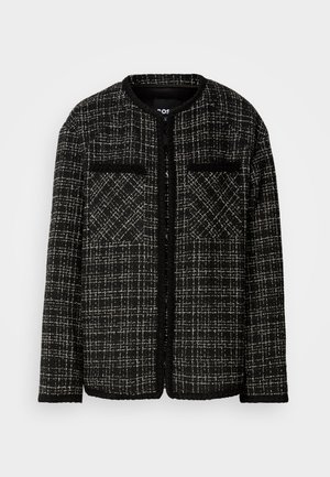 Black and white tweed jacket with a round neckline, two front pockets, and a textured check pattern. Open-front design with long sleeves.