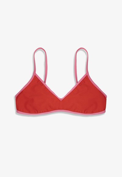 Haut court rouge en forme de triangle avec de fines bretelles roses et un bord rose autour des contours, posé à plat sur un fond blanc.