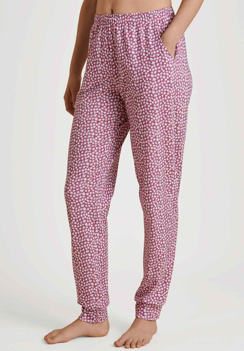 Roze geprinte pyjamabroek met witte bloemenpatronen, elastische tailleband, zijzakken, taps toelopende benen en omgeslagen boorden. Zacht, lichtgewicht stof.