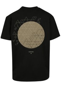 Black t-shirt featuring a large beige circle design with geometric patterns in varying shapes and lines on the back.
