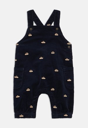 Navy blue baby corduroy overalls with beige embroidered car patterns, buttoned straps, and side pockets.