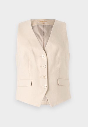 Beige-lihakuin puku, joka on valmistettu teksturoidusta kankaasta. Siinä on V-mallinen pääntie, neljä etunappia ja kaksi sivutaskua. Vuorattu sisäosa.