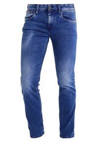 Modré džíny z denimu s úzkým střihem, designem pěti kapes a mírným vyblednutím na stehnech a kolenou. Mosazné zapínání na knoflík v pase.