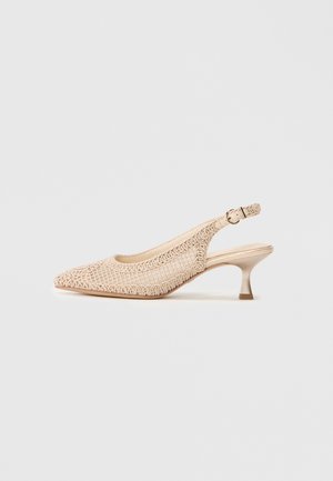 Beige slingback shoe with pointed toe, woven texture, and a low, metallic heel. Adjustable buckle strap at the back.