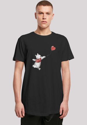 Black T-shirt featuring a cartoon bear with a red scarf, reaching for a red heart balloon, printed on the front in soft colors.
