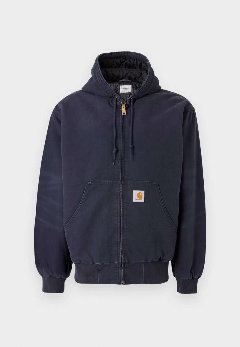 Marineblauwe rits hoodie gemaakt van katoen, met een gewatteerde binnenkant, koordjes bij de capuchon en een logo patch aan de voorkant.