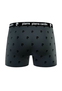 Boxers noirs avec une texture lisse, dotés d'un motif en spirale répétitif et d'une ceinture noire de marque.