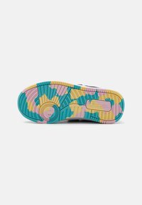 Multicolor sneaker outsole featuring a textured design with blue, pink, and yellow accents in a gradient pattern and circular tread details.